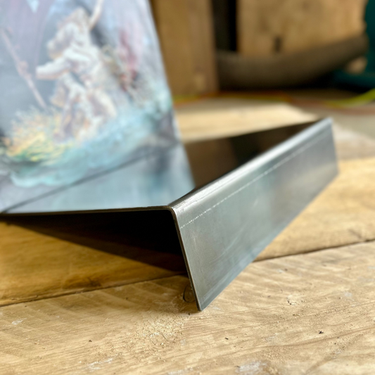 Made from raw steel and bent to allow 12" vinyl records to sit supported.