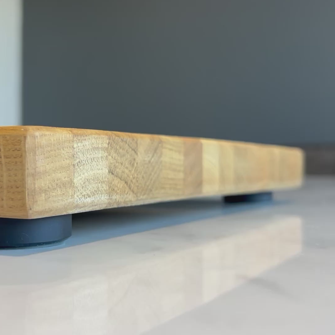 black non slip chopping board feet on an oak chopping board