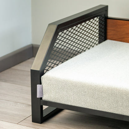 Modern pet bed with a luxury wood backrest raised off the floor to aid comfort and cleanliness.